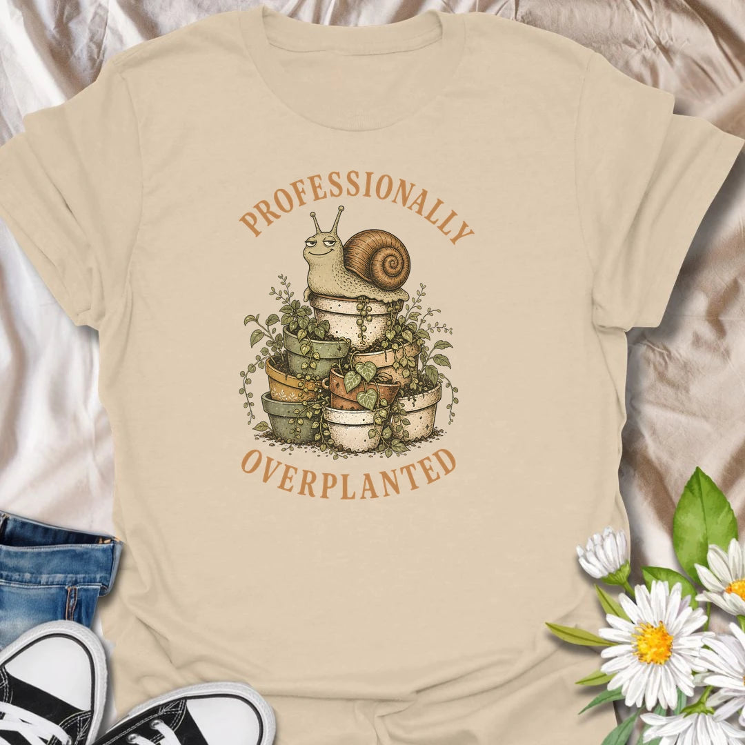 This Professionally Overplanted t-shirt is perfect for gardeners and plant lovers who know there is always room for one more pot. Featuring a smug garden snail sitting on a stack of overflowing potted plants, this funny botanical design is great for houseplant collectors, container gardeners, plant moms, plant dads, and anyone proudly guilty of overplanting.