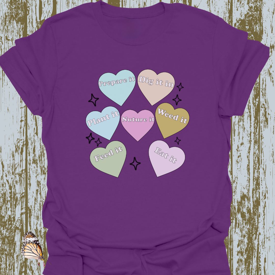 Hearts with plant-related text in pastel colors on a purple t-shirt