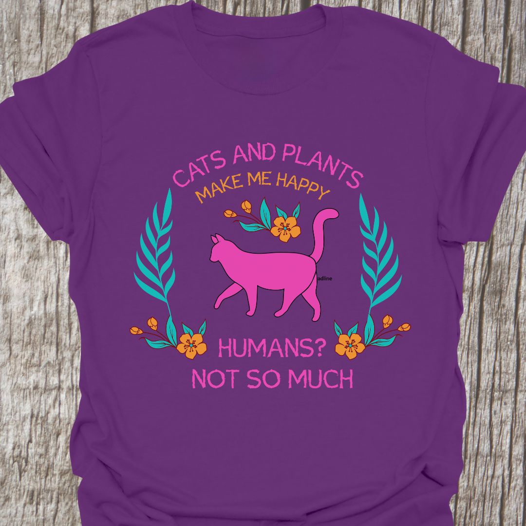 Cat and Plants Make Me Happy, Humans? Not So Much text and image design with pink cat as main image and decorative leaves, and flowers. Purple t-shirt