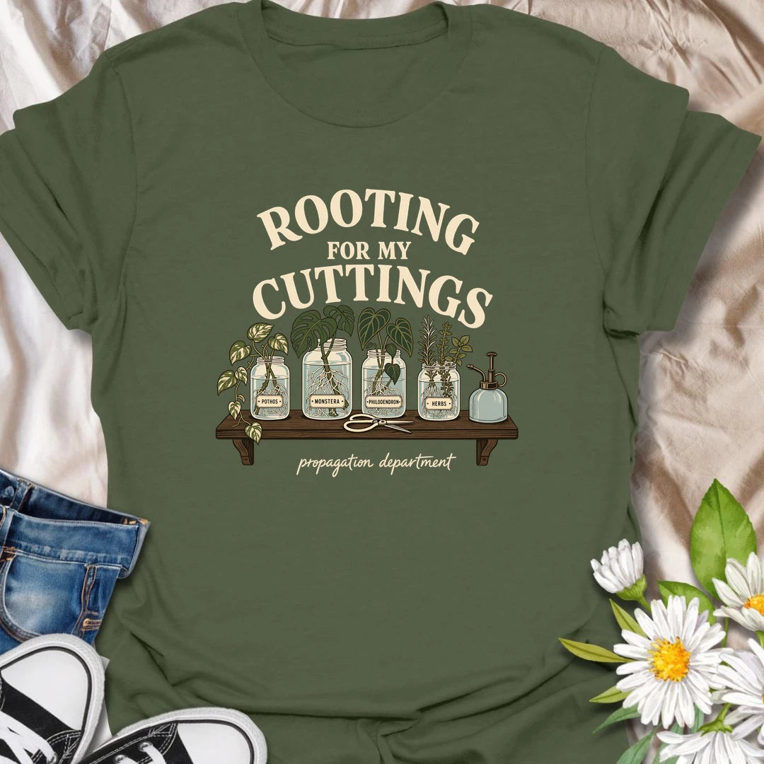 Cheer on every new root with this “Rooting for My Cuttings” T-shirt. The propagation-themed design features pothos, monstera, philodendron, and herb cuttings growing in glass jars. It is a thoughtful and funny gift for houseplant lovers who are always starting another plant baby.