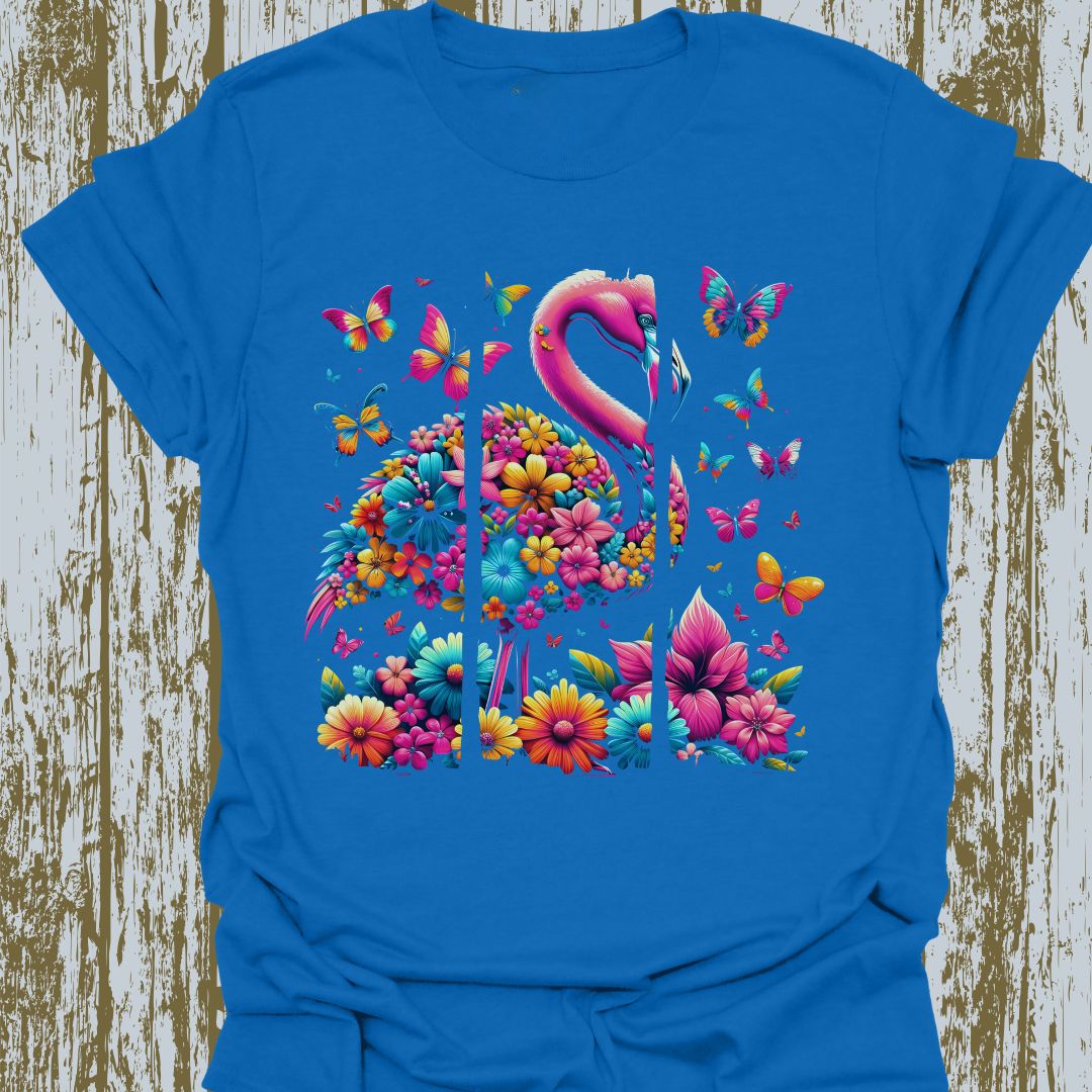 A design featuring flamingos, butterflies, and flowers in pink, yellow, and blue hues on royal blue t-shirt.
