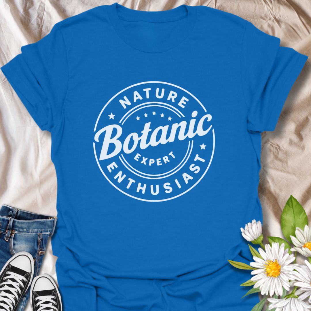 Show off your love for plants with this bold graphic t-shirt featuring the phrase "Nature Expert Botanic Enthusiast." This is in either white or black text, dependant on the color choice. This Tee is Perfect for gardeners, plant parents, and anyone passionate about botany, nature, and green living.