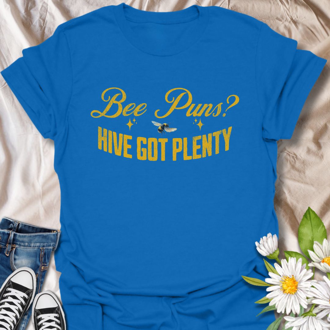 Funny "Bee Puns? Hive Got Plenty" t-shirt with vintage yellow typography and bee illustration on crisp white. Ideal for beekeepers, honey bee lovers, gardeners, pollinator supporters, and anyone who loves a clever bee pun. Great nature lover gift and perfect for eco-friendly fashion.