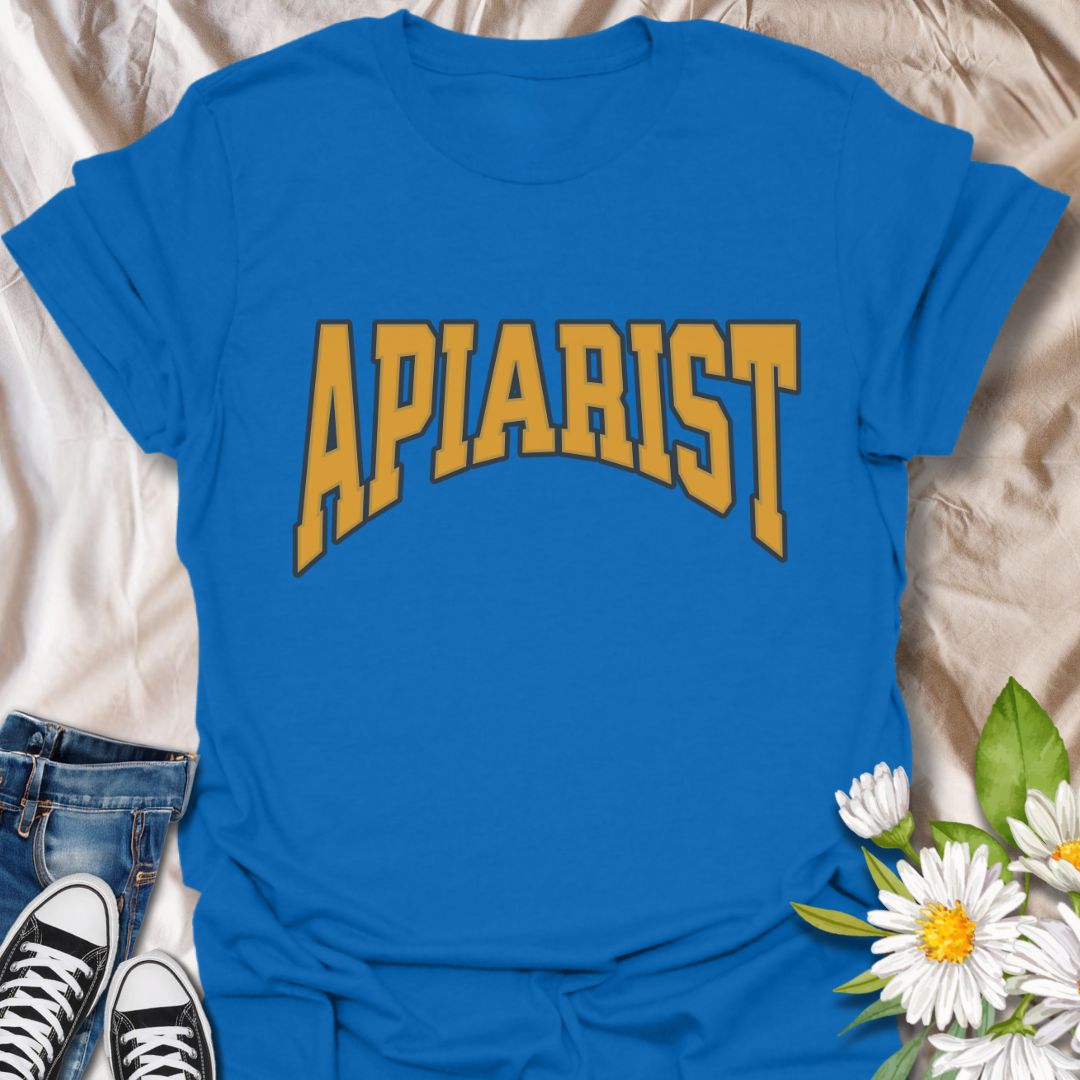 Simple bold "Apiarist" t-shirt with collegiate-style yellow lettering on black. Perfect for professional beekeepers, hobbyist beekeepers, honey producers, and bee conservation advocates. Great gift for anyone passionate about apiculture, bee science, or protecting pollinators.