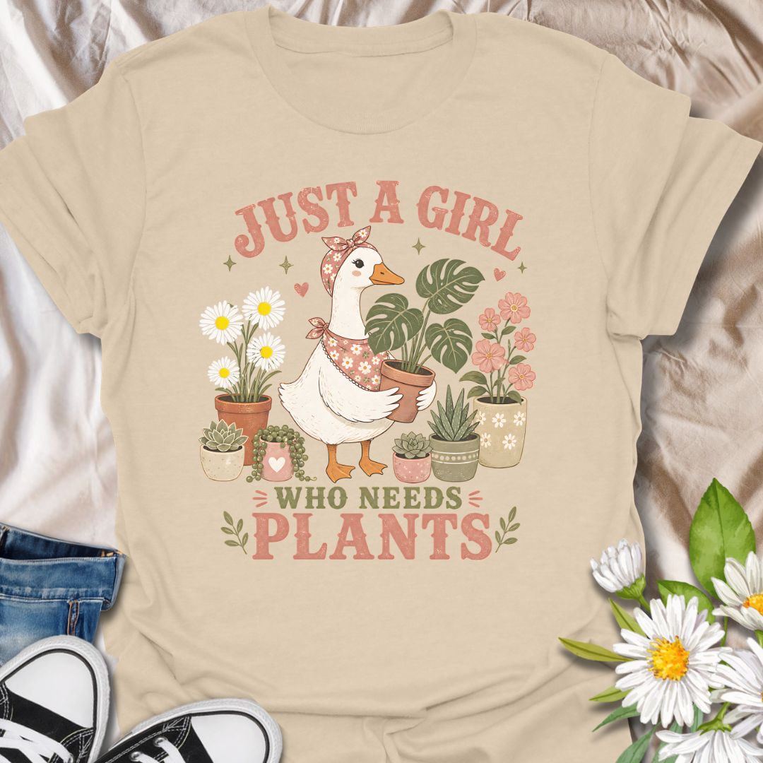 This Just A Girl Who Needs Plants t-shirt is made for plant lovers who know leafy friends, flowers, and a little garden time can fix almost anything. Featuring a sweet goose holding a potted monstera, surrounded by daisies, succulents, flowering plants, hearts, and soft botanical details, this design has a cute cottagecore-inspired feel. Perfect for plant moms, gardeners, houseplant collectors, flower fans, and anyone who proudly needs more plants in their life.