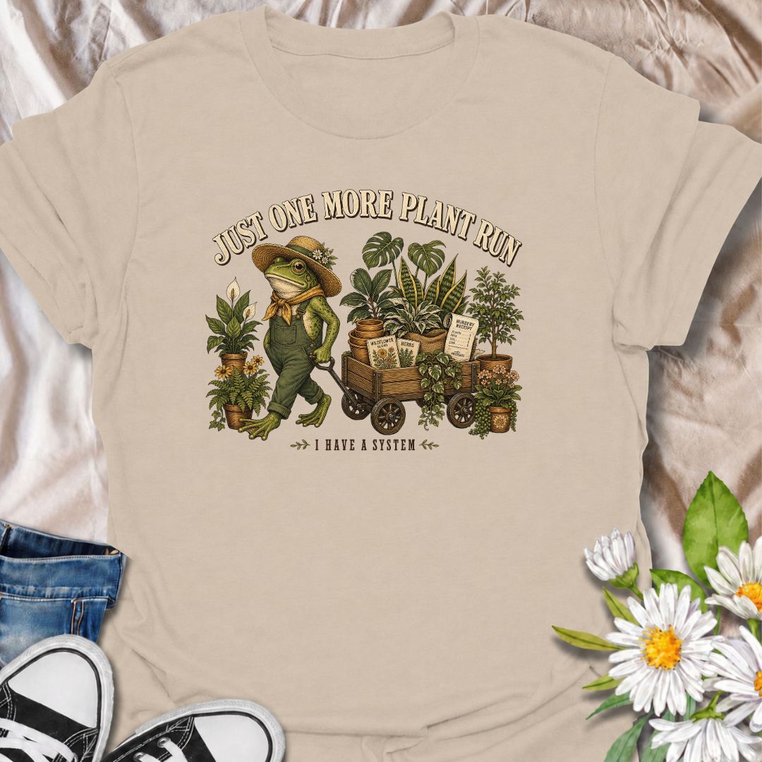 A funny plant-shopping T-shirt featuring a stylish frog and a wagon full of nursery finds. Made for plant lovers who can never buy just one more.
