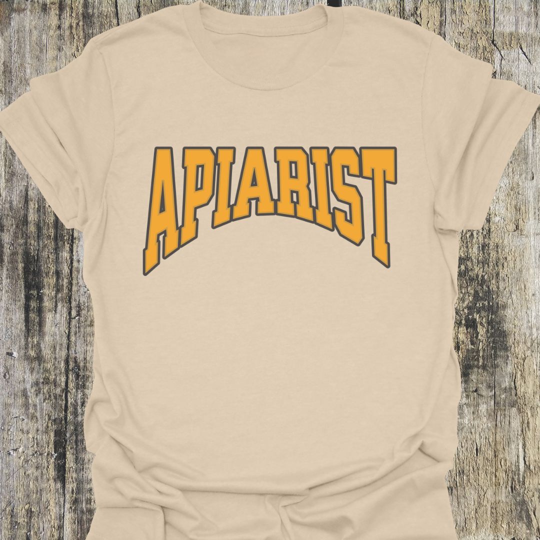 Apiarist T-shirt on sand background with yellow text and black bordder