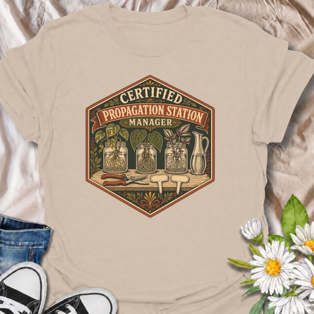 Show off your plant-growing expertise with this “Certified Propagation Station Manager” T-shirt. Featuring rooted cuttings in glass jars, plant markers, pruning shears, and a vintage badge-style design, it is perfect for plant lovers who always have a propagation project underway. A fun gift for houseplant collectors, plant moms, and indoor gardeners.