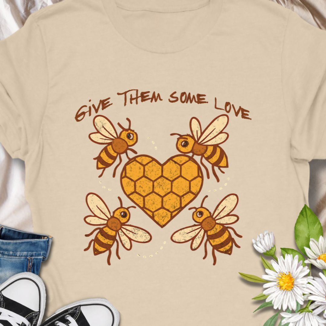 Show your support for the bees with this adorable “Give Them Some Love” t-shirt featuring four cartoon bees buzzing around a heart-shaped honeycomb. It’s the perfect nature-inspired shirt for bee lovers, pollinator advocates, and environmentalists. A sweet way to spread awareness and style!