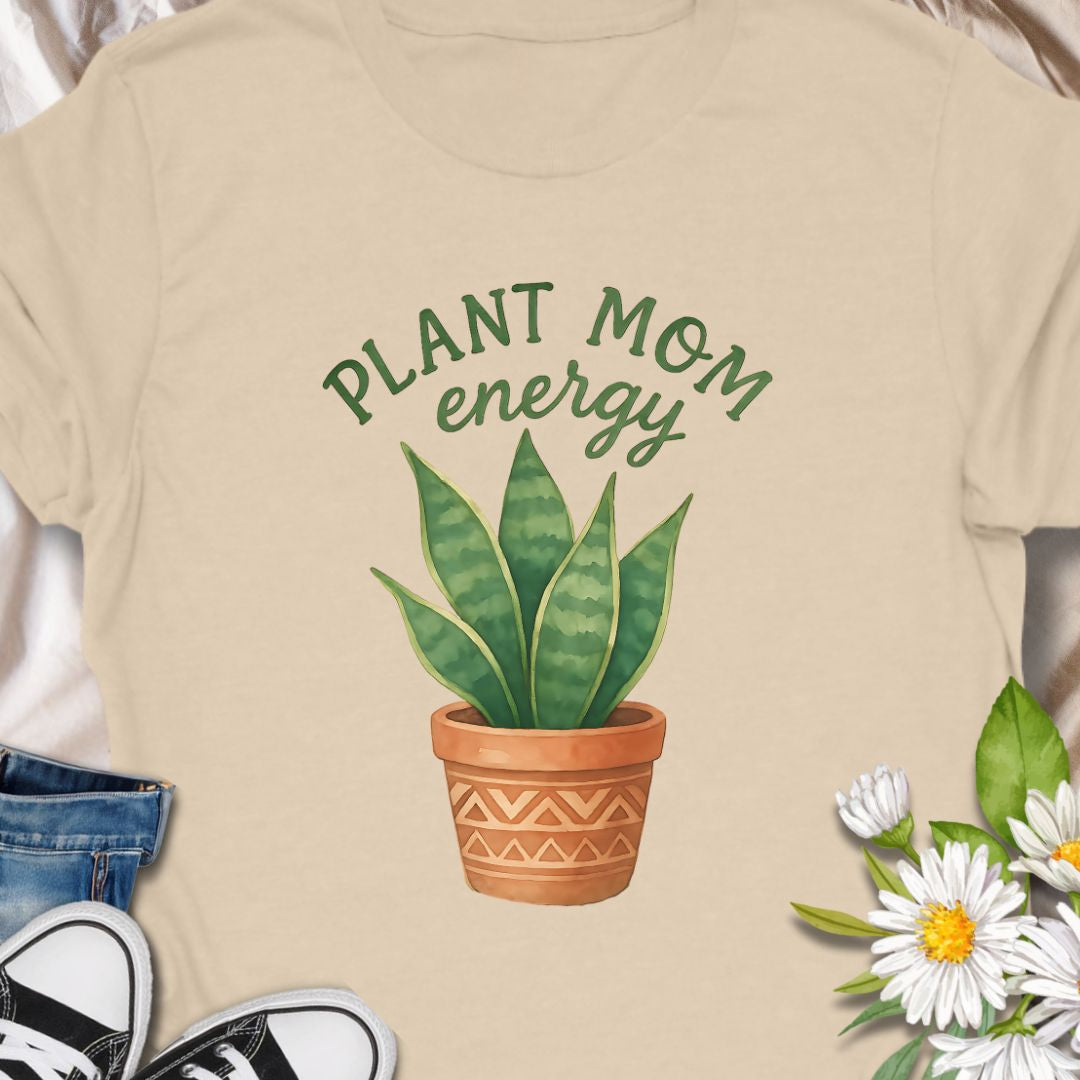 Show off your green thumb with this stylish “Plant Mom Energy” t-shirt featuring a beautiful snake plant in a terracotta pot. Perfect for indoor gardeners and houseplant lovers, this tee radiates nurturing vibes and earthy style. A cozy, cute wardrobe essential for any proud plant mom!