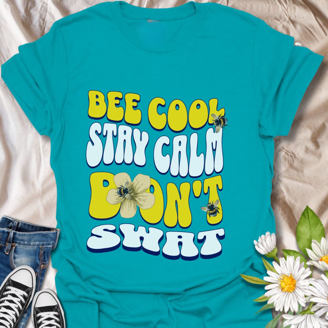 Playful bee-themed t-shirt with "Bee Cool Stay Calm Don't Swat" design. Fun gift for bee lovers, pollinator enthusiasts, and anyone who appreciates a lighthearted garden vibe. Tropical blue