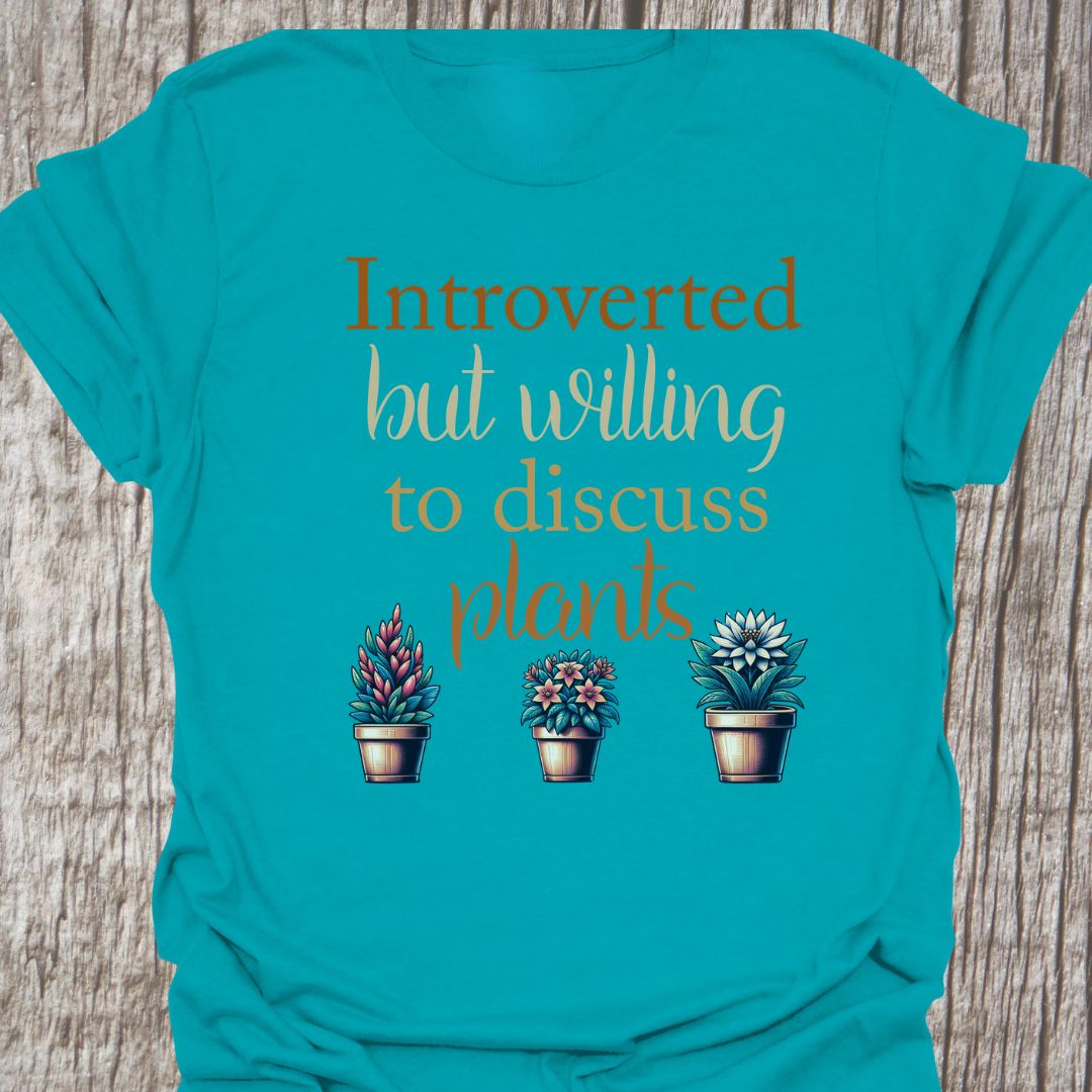 Introverted but willing to discuss plants in natural colored text with image of three flowering pot plants, on a tropical t-shirt