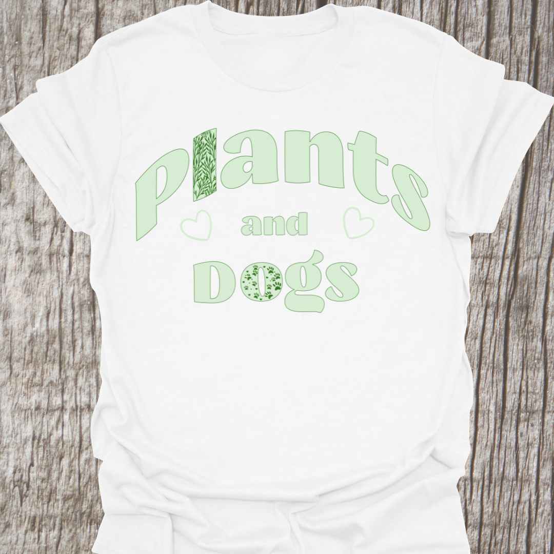 Plants and Dogs in text with subtle paw prints and leaves within the text design, decorated with two small hearts. Light green on a white t-shirt