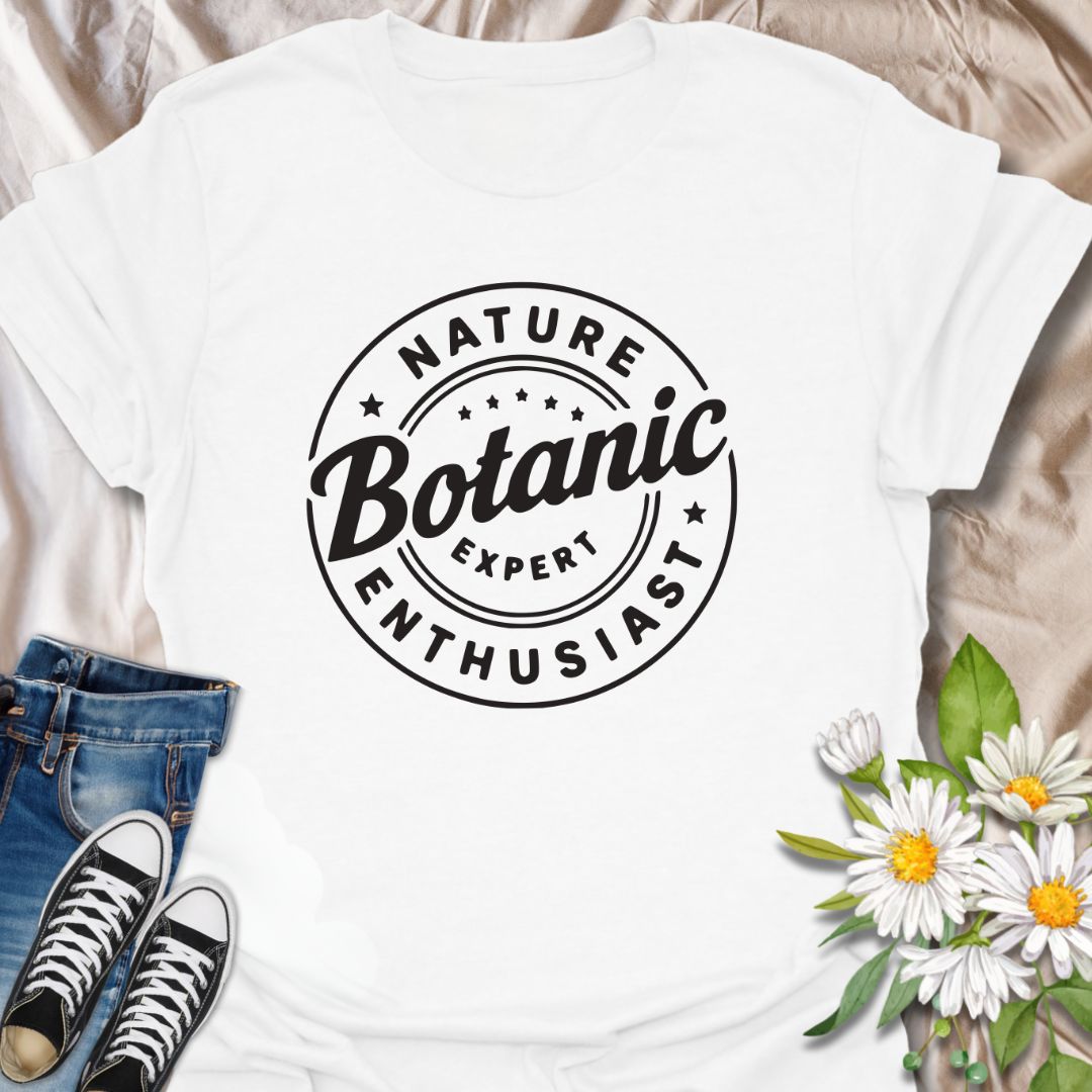 Show off your love for plants with this bold graphic t-shirt featuring the phrase "Nature Expert Botanic Enthusiast." This is in either white or black text, dependant on the color choice. This Tee is Perfect for gardeners, plant parents, and anyone passionate about botany, nature, and green living.