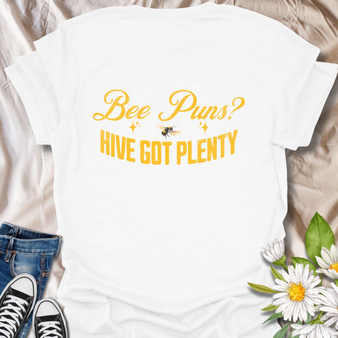 Funny "Bee Puns? Hive Got Plenty" t-shirt with vintage yellow typography and bee illustration on crisp white. Ideal for beekeepers, honey bee lovers, gardeners, pollinator supporters, and anyone who loves a clever bee pun. Great nature lover gift and perfect for eco-friendly fashion.