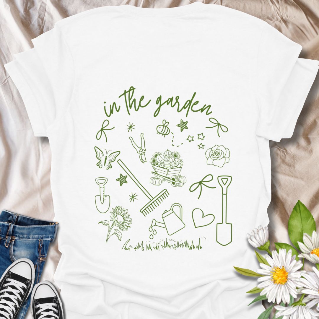 Charming "In The Garden" doodle style t-shirt with hand-drawn gardening tools, flowers, and butterflies. Perfect gift for gardeners, plant lovers, and nature enthusiasts. Stylish botanical apparel for spring, summer, or everyday wear. Celebrate your green thumb!