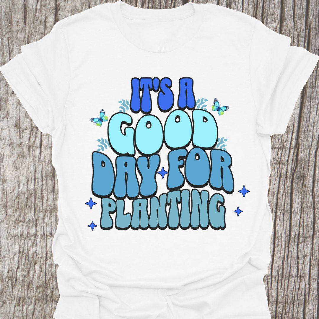 It's a good day for planting written in various shades of blue text with small stars and buterflies decorating it, on a white t-shirt