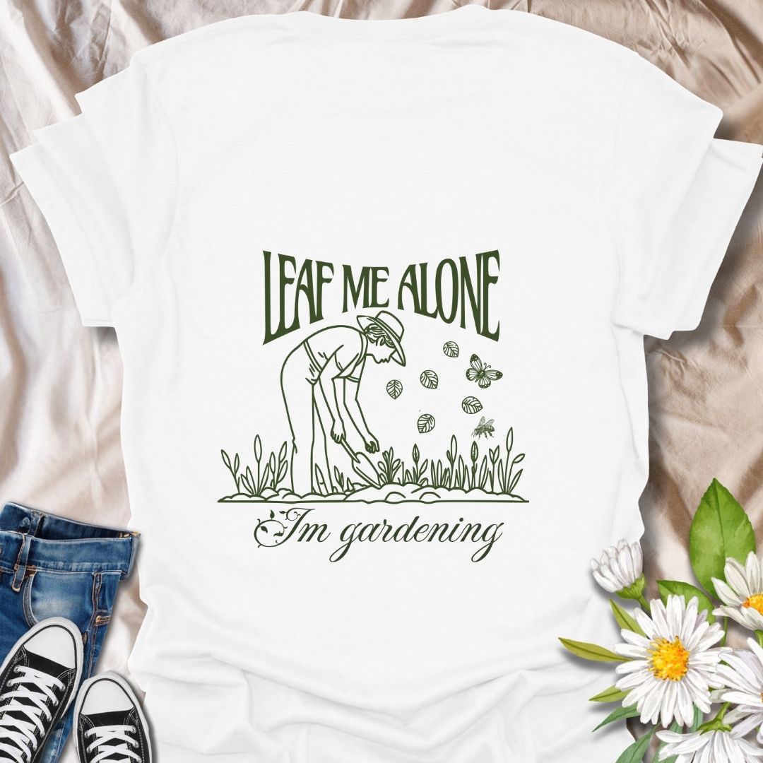 Perfect for plant lovers with a sense of humor! This "Leaf Me Alone I’m Gardening" t-shirt features a playful gardening pun with a simple, charming line art design. Great gift for gardeners who enjoy their peaceful time outdoors.