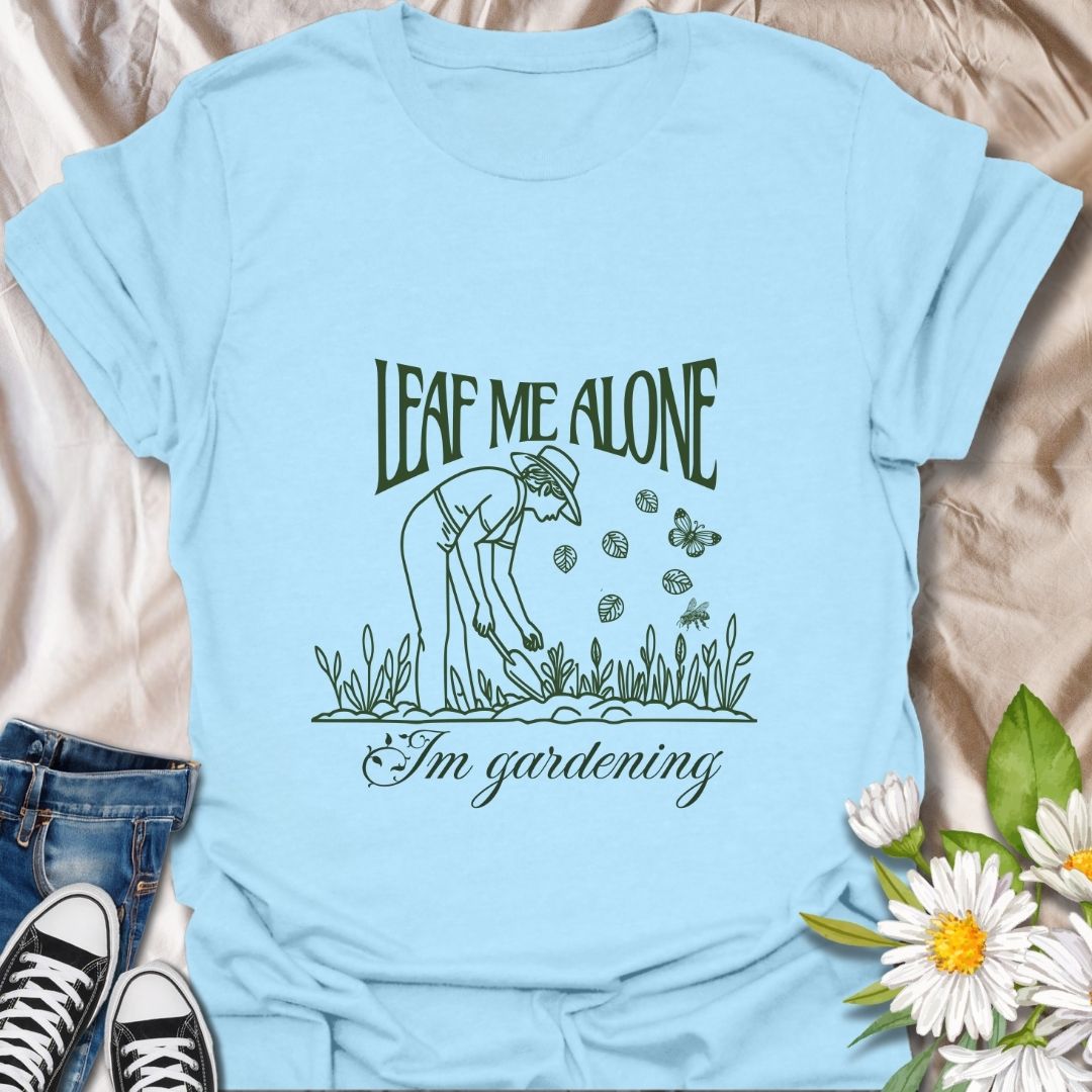 Perfect for plant lovers with a sense of humor! This "Leaf Me Alone I’m Gardening" t-shirt features a playful gardening pun with a simple, charming line art design. Great gift for gardeners who enjoy their peaceful time outdoors.