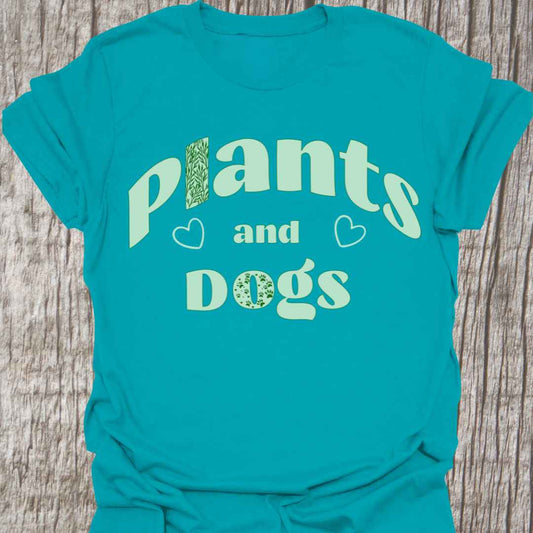 Plants and Dogs in text with subtle paw prints and leaves within the text design, decorated with two small hearts.   Light green on a tropical color t-shirt