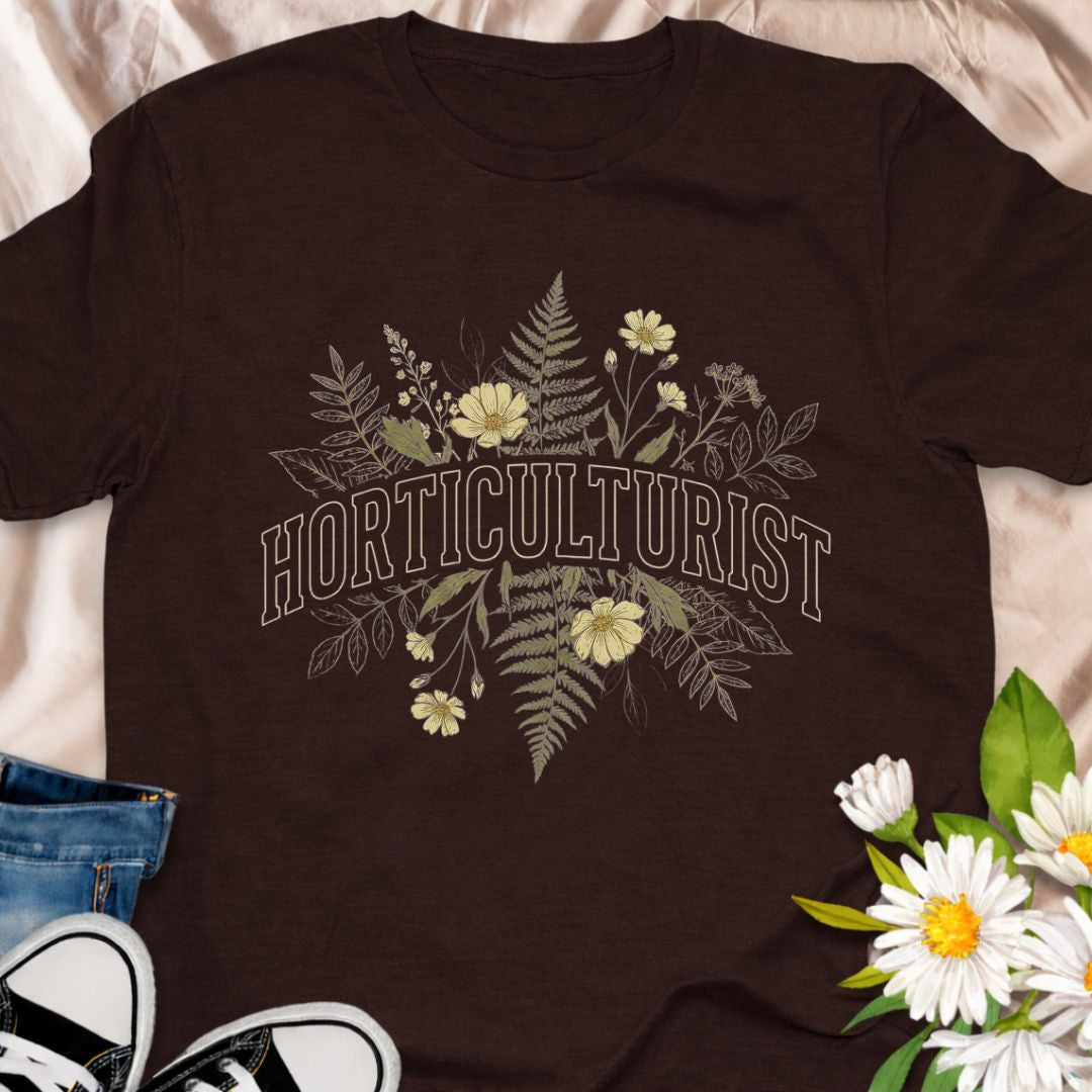 Celebrate your love of plants with this Horticulturist shirt featuring a vintage-inspired botanical design with delicate florals and foliage. Perfect for gardeners, plant lovers, and flower enthusiasts, this soft unisex tee makes a thoughtful gift for birthdays, Mother’s Day, Father's Day or everyday garden pride.