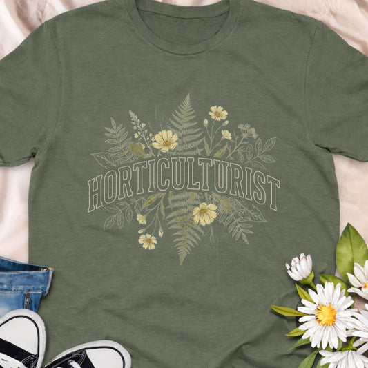 Celebrate your love of plants with this Horticulturist shirt featuring a vintage-inspired botanical design with delicate florals and foliage. Perfect for gardeners, plant lovers, and flower enthusiasts, this soft unisex tee makes a thoughtful gift for birthdays, Mother’s Day, Father's Day or everyday garden pride.