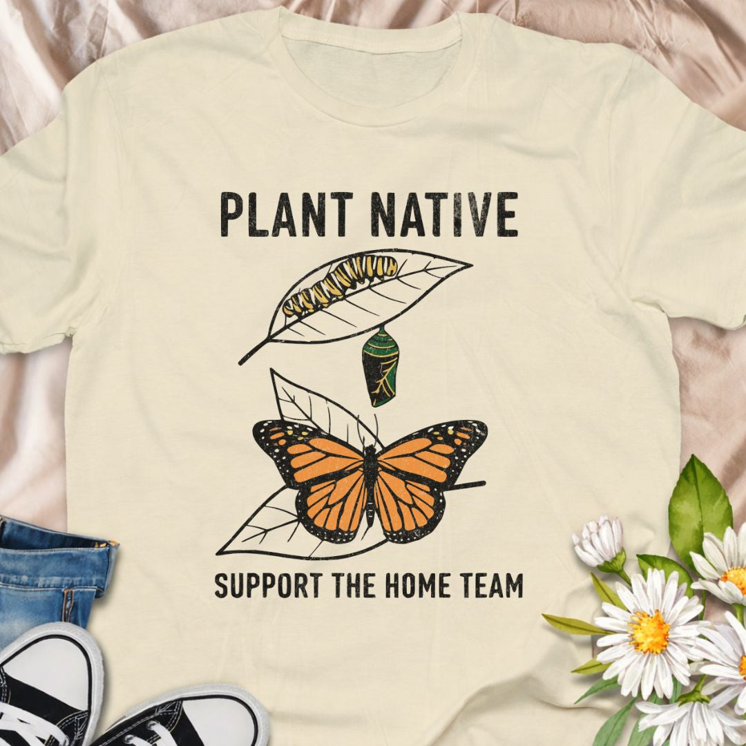 Plant native. Support the home team. This butterfly and native plant shirt celebrates sustainable gardening and local wildlife. Featuring a delicate nature-inspired design, this soft unisex tee is perfect for pollinator gardeners, native plant lovers, and eco-conscious nature enthusiasts.