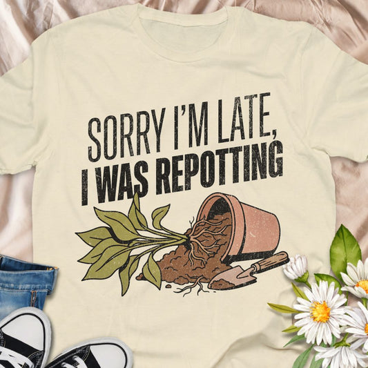 Sorry I’m late, I was repotting. The perfect funny plant lover shirt for anyone obsessed with houseplants and gardening. Featuring a charming repotting graphic design, this soft unisex tee makes a great gift for plant parents, indoor gardeners, and plant addicts.