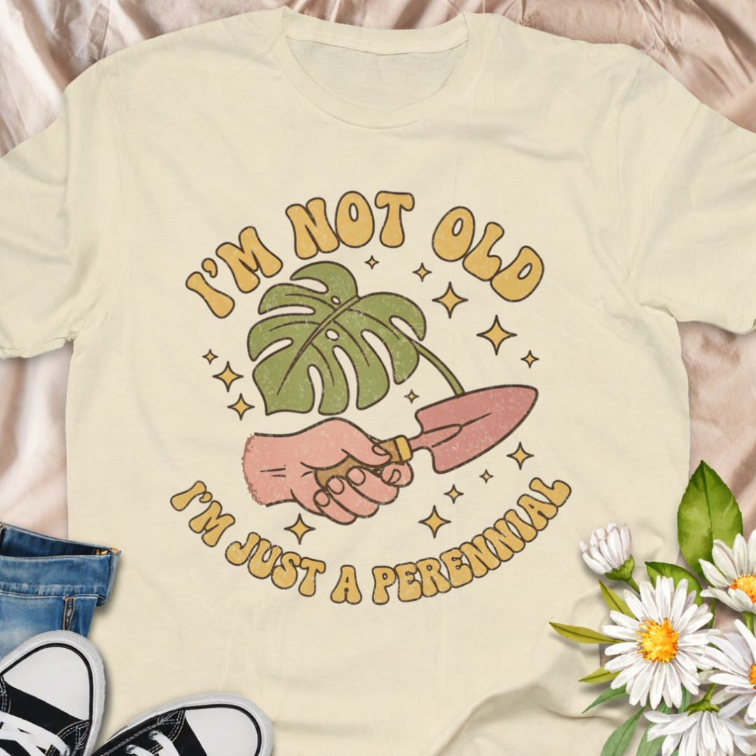 Celebrate aging with humor in this “I’m Not Old, I’m Just a Perennial” gardening t-shirt. A funny plant lover shirt perfect for gardeners, plant moms, and anyone who knows perennials only get better with time. Great gift for birthdays, garden club friends, and botanical enthusiasts.