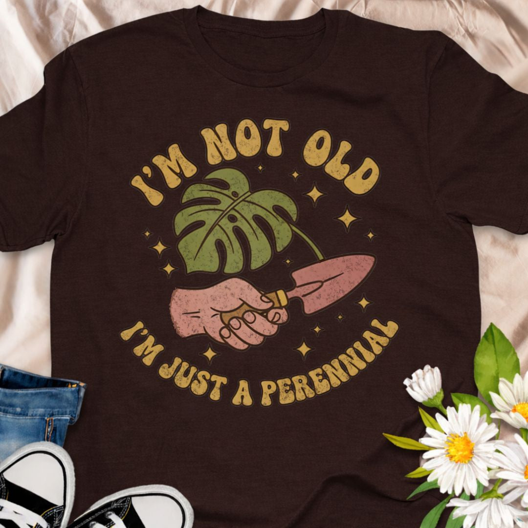 Celebrate aging with humor in this “I’m Not Old, I’m Just a Perennial” gardening t-shirt. A funny plant lover shirt perfect for gardeners, plant moms, and anyone who knows perennials only get better with time. Great gift for birthdays, garden club friends, and botanical enthusiasts.
