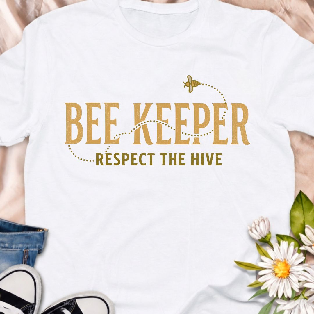 Show your passion for beekeeping with this “Bee Keeper – Respect the Hive” t-shirt. Perfect for beekeepers, pollinator supporters, and nature lovers who appreciate the vital role bees play in our ecosystems.