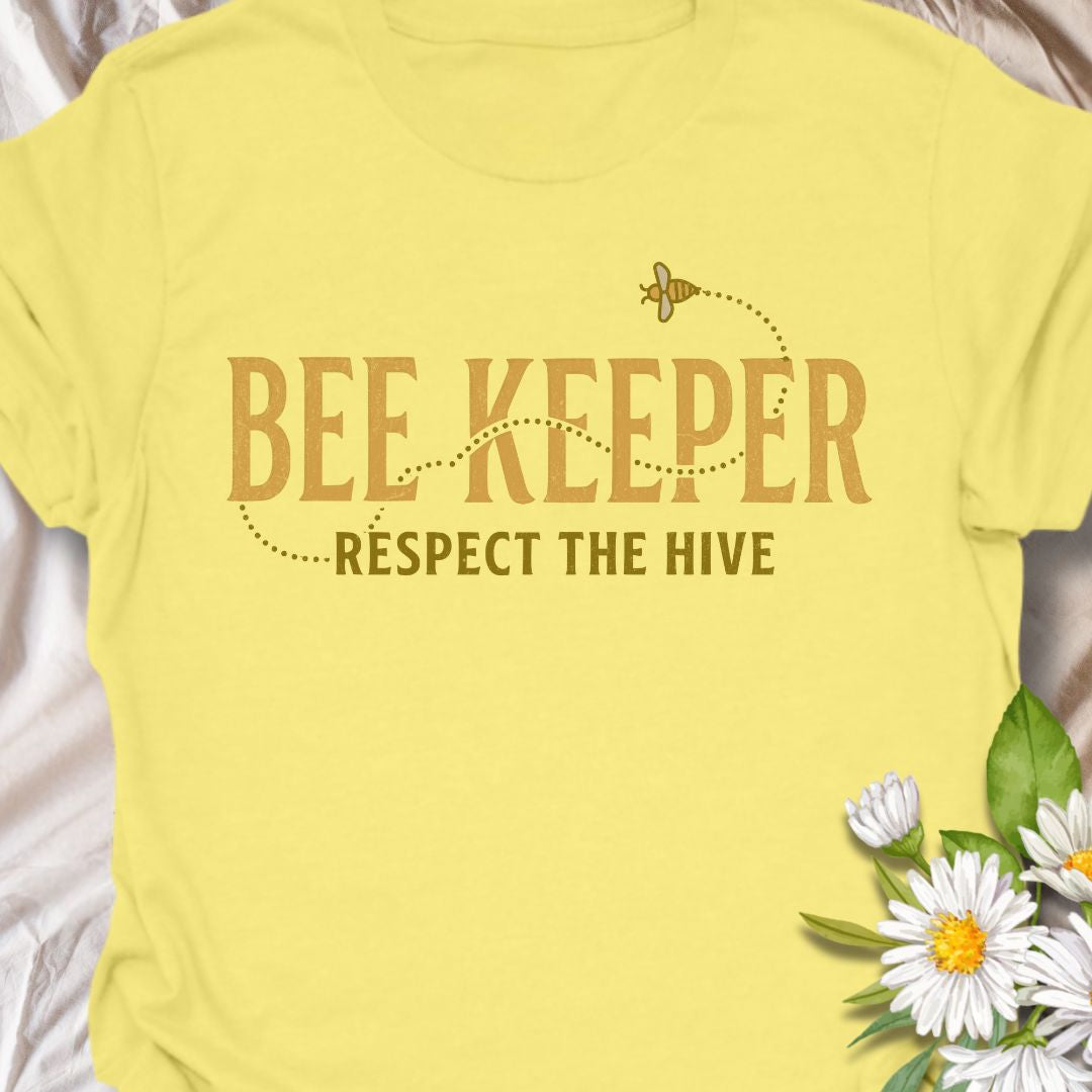 Show your passion for beekeeping with this “Bee Keeper – Respect the Hive” t-shirt. Perfect for beekeepers, pollinator supporters, and nature lovers who appreciate the vital role bees play in our ecosystems.