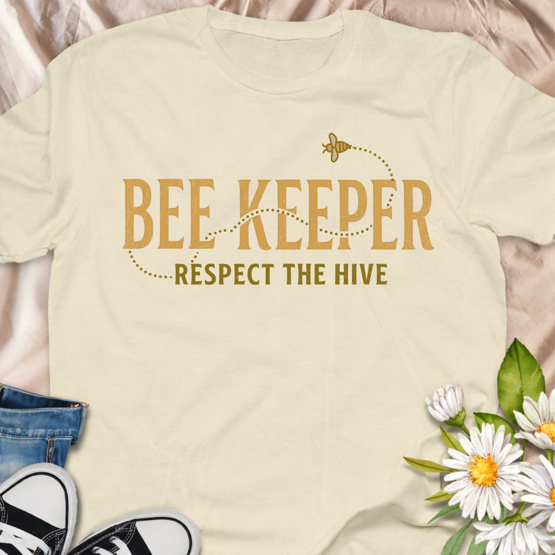 Show your passion for beekeeping with this “Bee Keeper – Respect the Hive” t-shirt. Perfect for beekeepers, pollinator supporters, and nature lovers who appreciate the vital role bees play in our ecosystems.