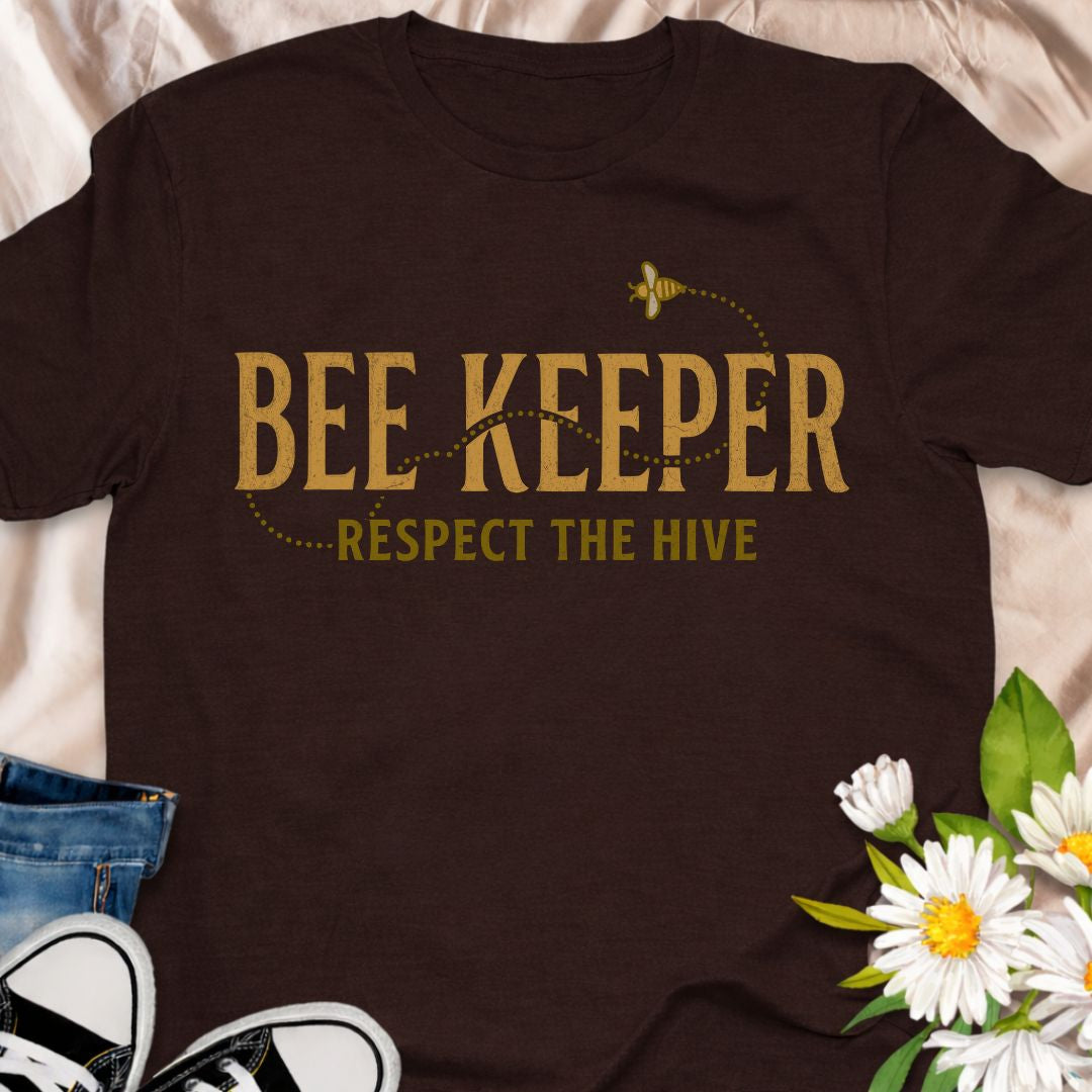 Show your passion for beekeeping with this “Bee Keeper – Respect the Hive” t-shirt. Perfect for beekeepers, pollinator supporters, and nature lovers who appreciate the vital role bees play in our ecosystems.
