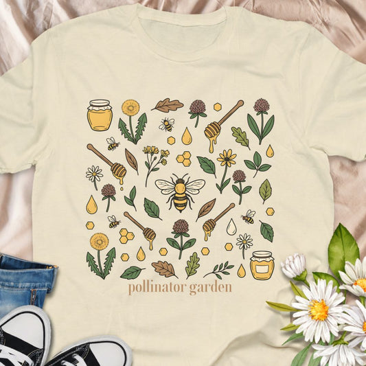 Celebrate nature with this “Pollinator Garden” t-shirt featuring bees, honey jars, wildflowers, and garden elements. Perfect for gardeners, bee lovers, and anyone passionate about creating pollinator-friendly gardens.