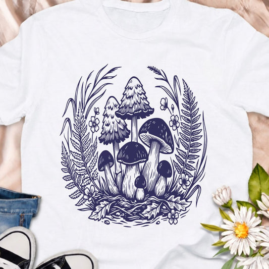 Beautiful woodland mushroom t-shirt featuring detailed forest fungi surrounded by ferns and wild plants in a botanical illustration style. Perfect for mushroom lovers, nature enthusiasts, gardeners, and fans of cottage core forest aesthetics.