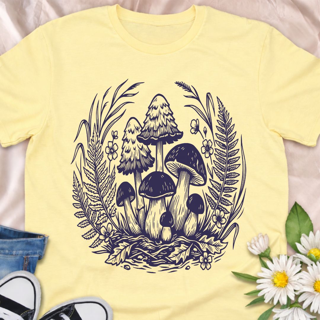 Beautiful woodland mushroom t-shirt featuring detailed forest fungi surrounded by ferns and wild plants in a botanical illustration style. Perfect for mushroom lovers, nature enthusiasts, gardeners, and fans of cottage core forest aesthetics.