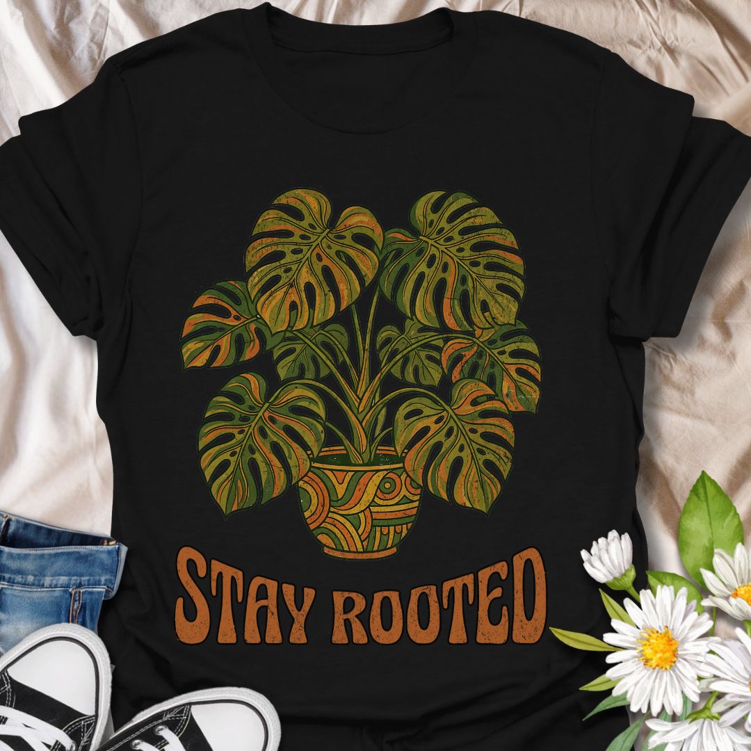 Stylish plant lover t-shirt featuring a vibrant monstera design with “Stay Rooted.” Perfect for plant parents, nature lovers, and botanical aesthetics. A positive, nature-inspired tee ideal for everyday wear or thoughtful gifting.