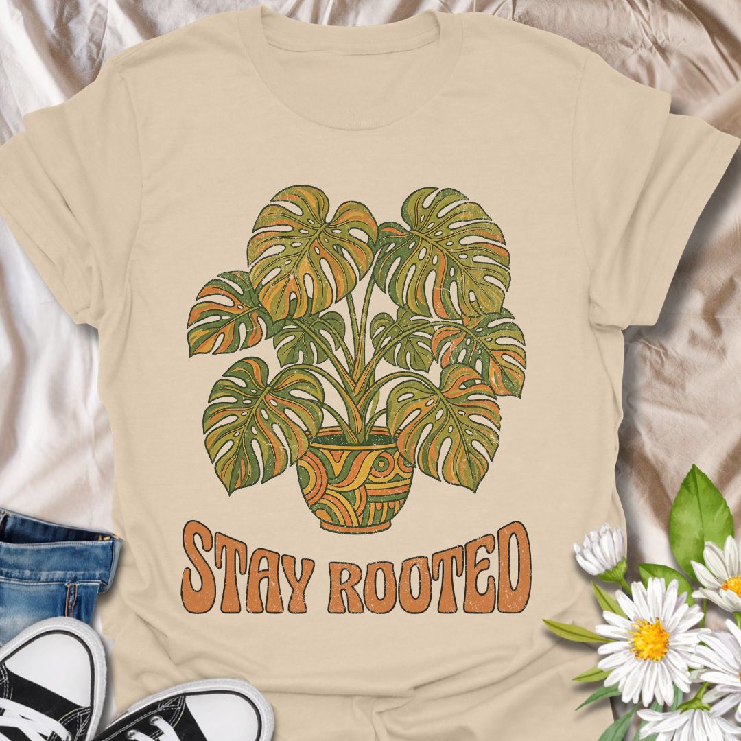 Stylish plant lover t-shirt featuring a vibrant monstera design with “Stay Rooted.” Perfect for plant parents, nature lovers, and botanical aesthetics. A positive, nature-inspired tee ideal for everyday wear or thoughtful gifting.