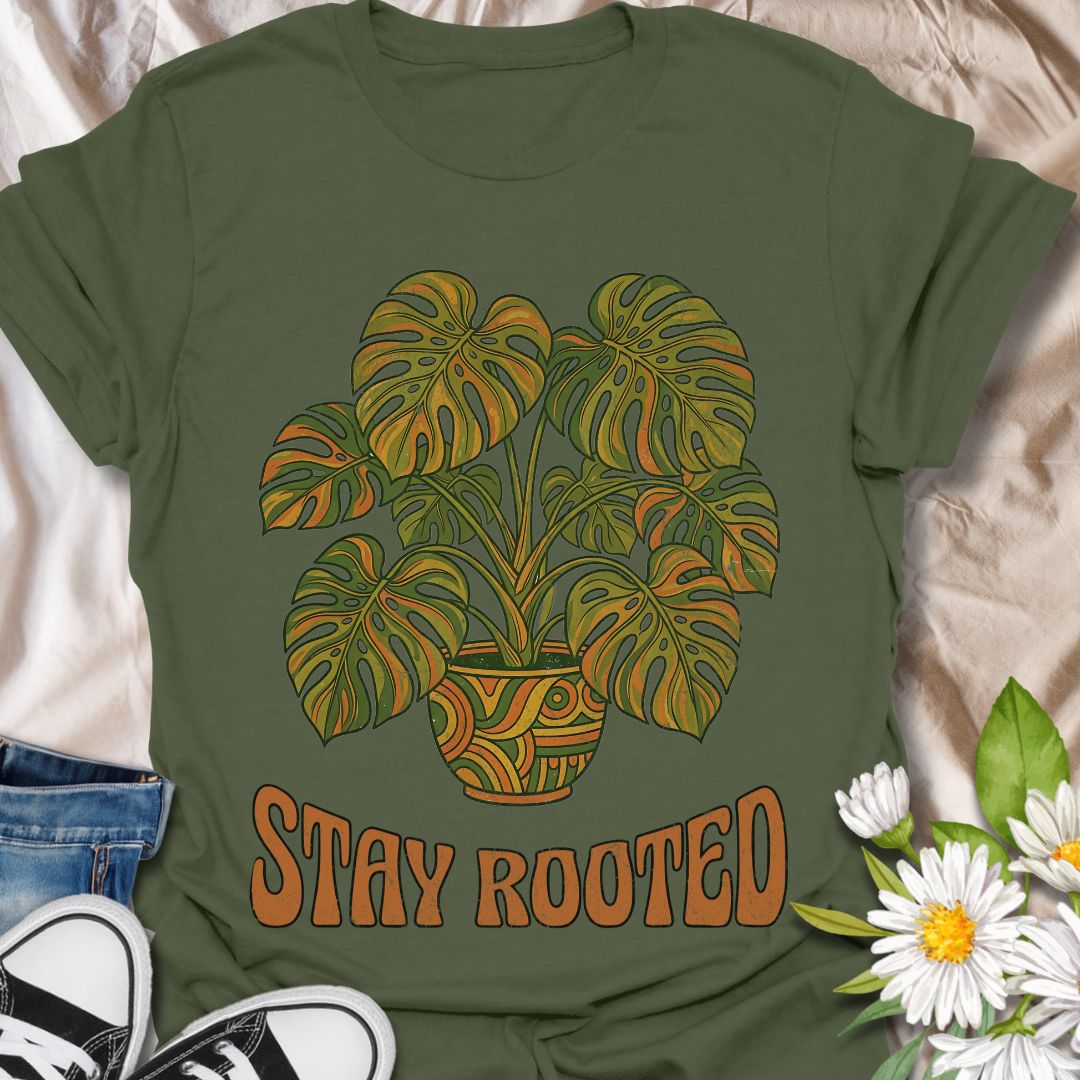 Stylish plant lover t-shirt featuring a vibrant monstera design with “Stay Rooted.” Perfect for plant parents, nature lovers, and botanical aesthetics. A positive, nature-inspired tee ideal for everyday wear or thoughtful gifting.