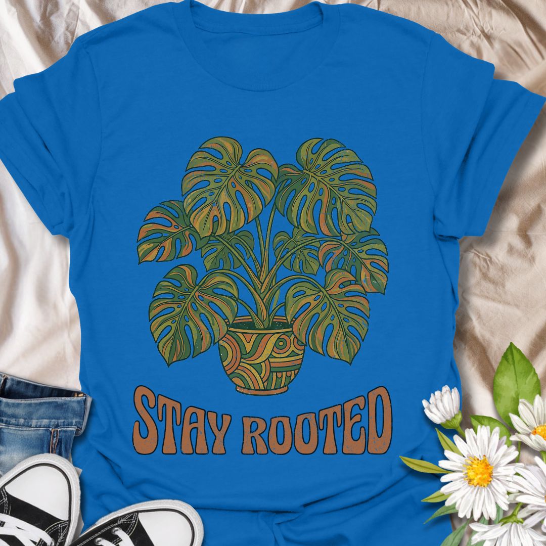 Stylish plant lover t-shirt featuring a vibrant monstera design with “Stay Rooted.” Perfect for plant parents, nature lovers, and botanical aesthetics. A positive, nature-inspired tee ideal for everyday wear or thoughtful gifting.