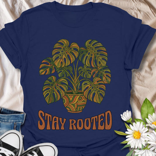 Stylish plant lover t-shirt featuring a vibrant monstera design with “Stay Rooted.” Perfect for plant parents, nature lovers, and botanical aesthetics. A positive, nature-inspired tee ideal for everyday wear or thoughtful gifting.