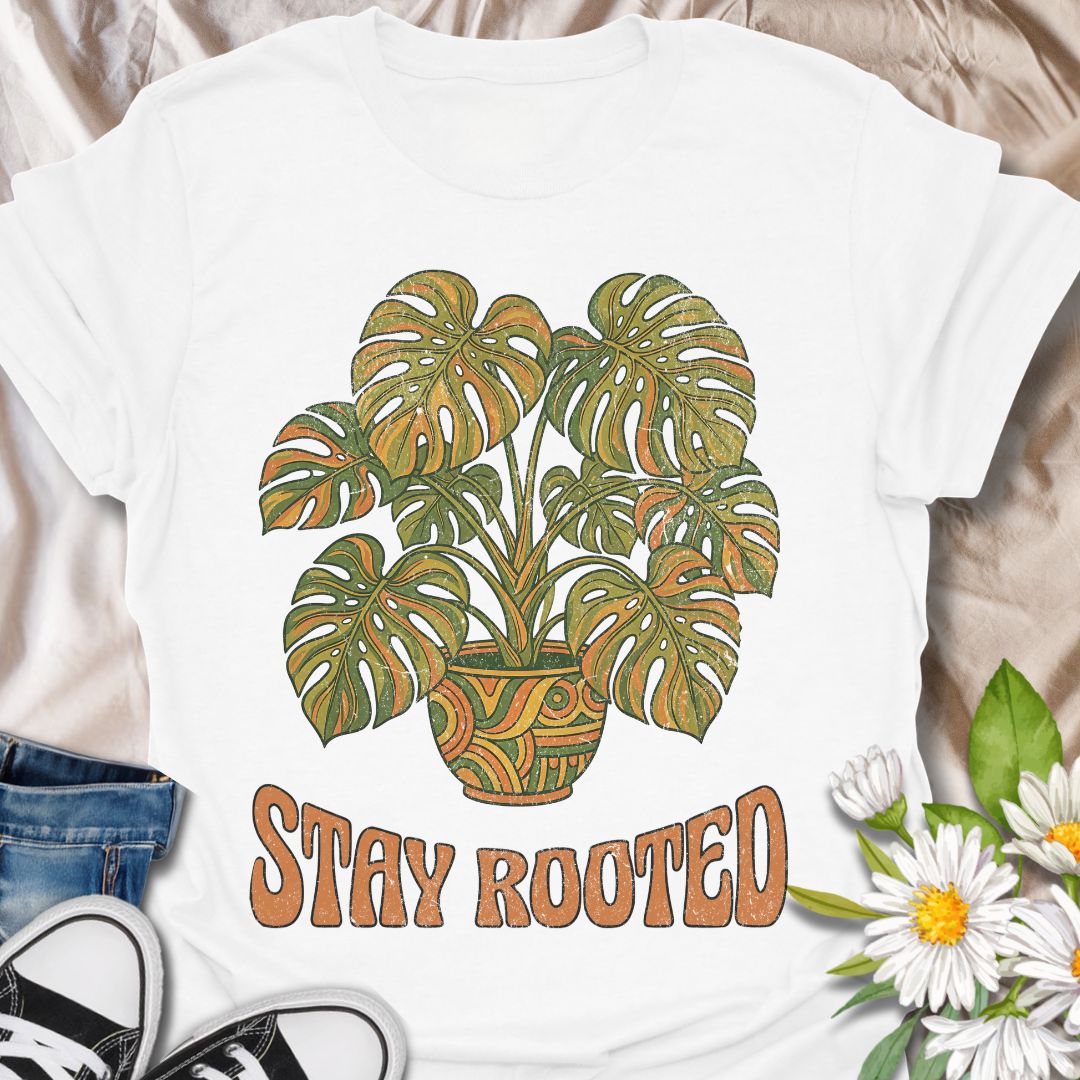 Stylish plant lover t-shirt featuring a vibrant monstera design with “Stay Rooted.” Perfect for plant parents, nature lovers, and botanical aesthetics. A positive, nature-inspired tee ideal for everyday wear or thoughtful gifting.