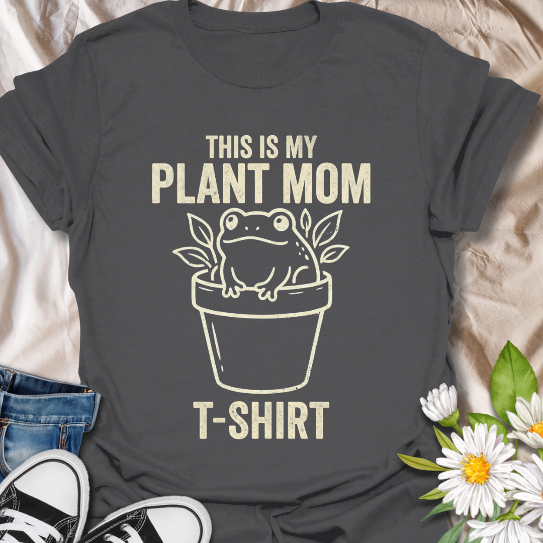 Funny plant mom t-shirt featuring a cute frog sitting in a flower pot with leafy botanical details. A playful plant lover tee for houseplant fans, indoor gardeners, and anyone proud of their plant mom era.