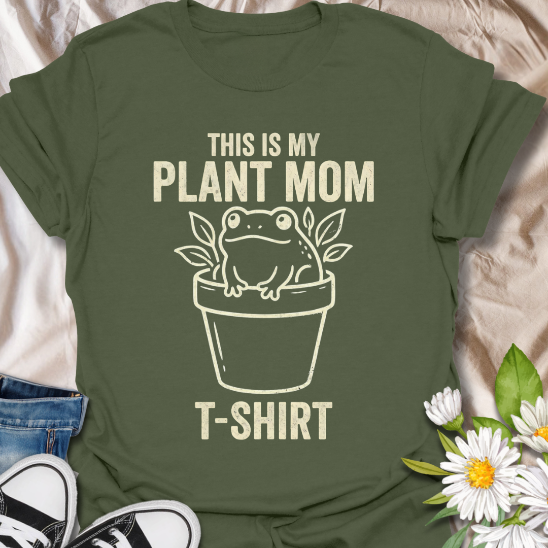 Funny plant mom t-shirt featuring a cute frog sitting in a flower pot with leafy botanical details. A playful plant lover tee for houseplant fans, indoor gardeners, and anyone proud of their plant mom era.