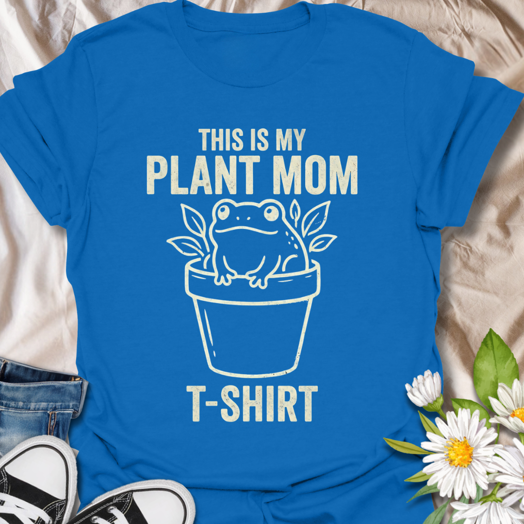 Funny plant mom t-shirt featuring a cute frog sitting in a flower pot with leafy botanical details. A playful plant lover tee for houseplant fans, indoor gardeners, and anyone proud of their plant mom era.