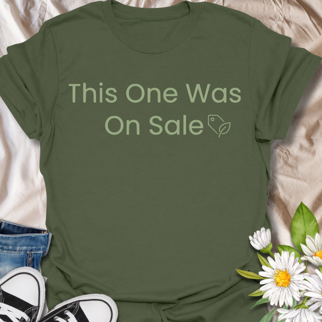 Funny plant lover t-shirt featuring the phrase “This One Was On Sale” with a simple botanical tag icon. A relatable houseplant tee for plant parents, indoor plant fans, and anyone who always makes room for one more plant.