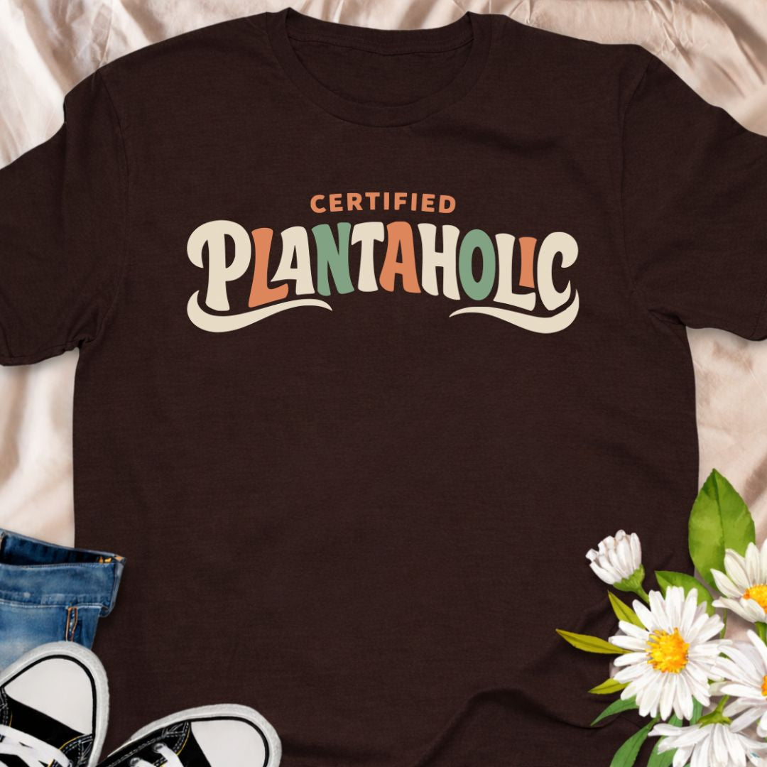 Funny plant lover t-shirt featuring the phrase “Certified Plantaholic” in a retro botanical style. A playful houseplant tee for plant parents, indoor gardeners, and anyone proudly obsessed with plants.