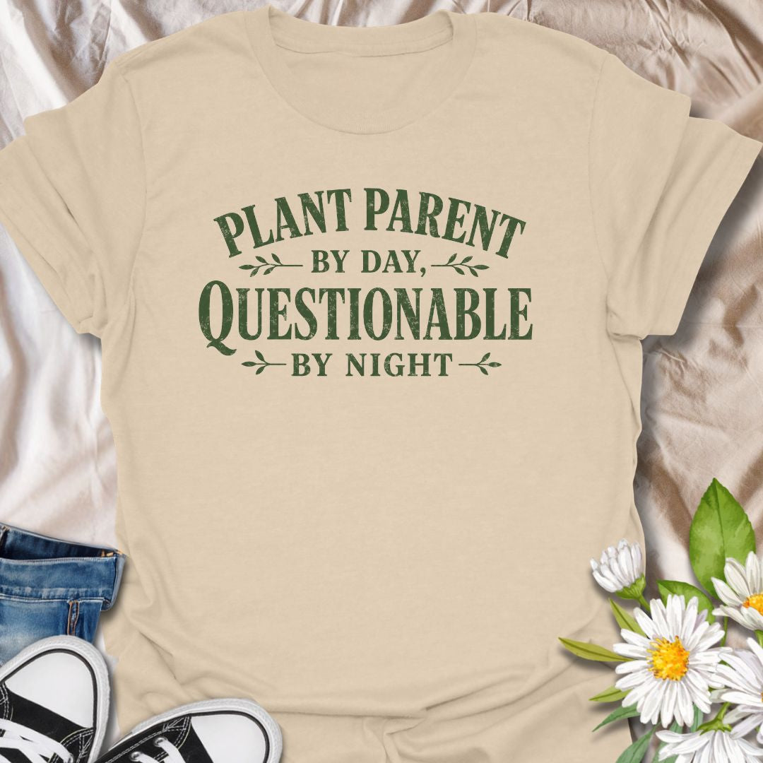 Funny plant lover t-shirt featuring the phrase “Plant Parent by Day, Questionable by Night.” A playful tee for plant parents, houseplant lovers, indoor gardeners, and anyone with a slightly mischievous sense of humor and a serious love of plants.
