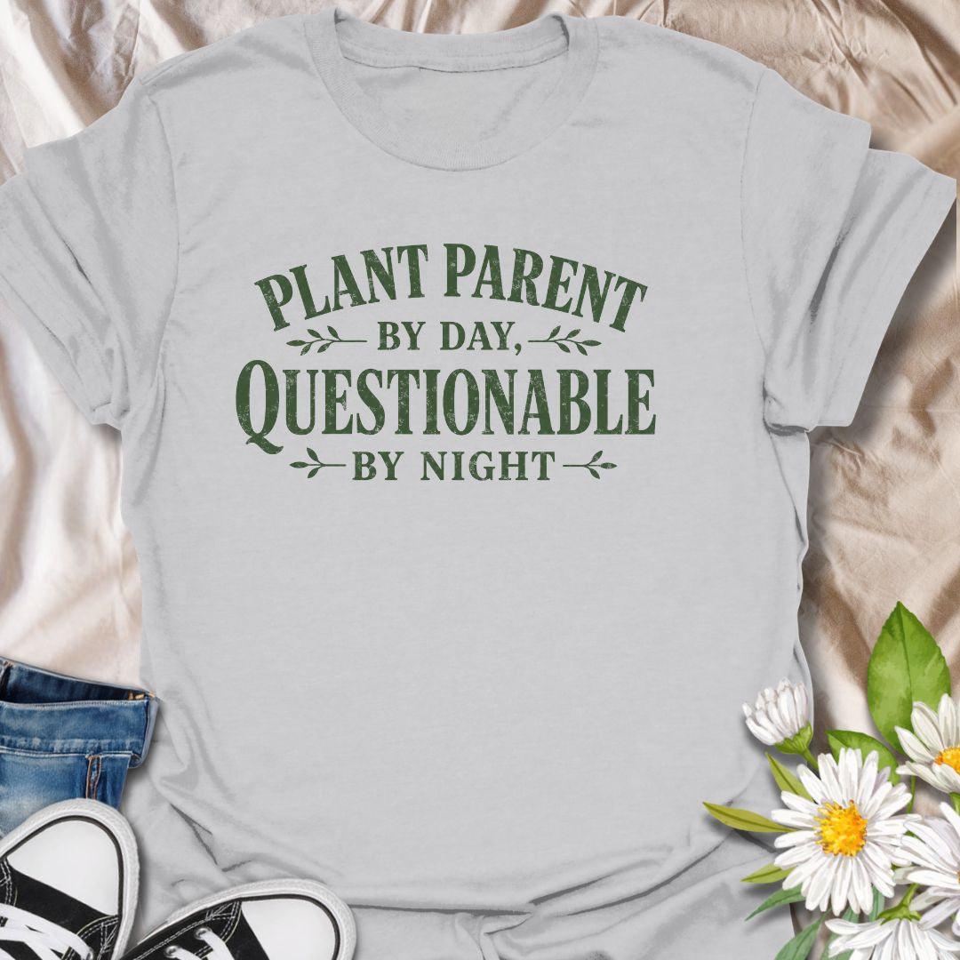Funny plant lover t-shirt featuring the phrase “Plant Parent by Day, Questionable by Night.” A playful tee for plant parents, houseplant lovers, indoor gardeners, and anyone with a slightly mischievous sense of humor and a serious love of plants.